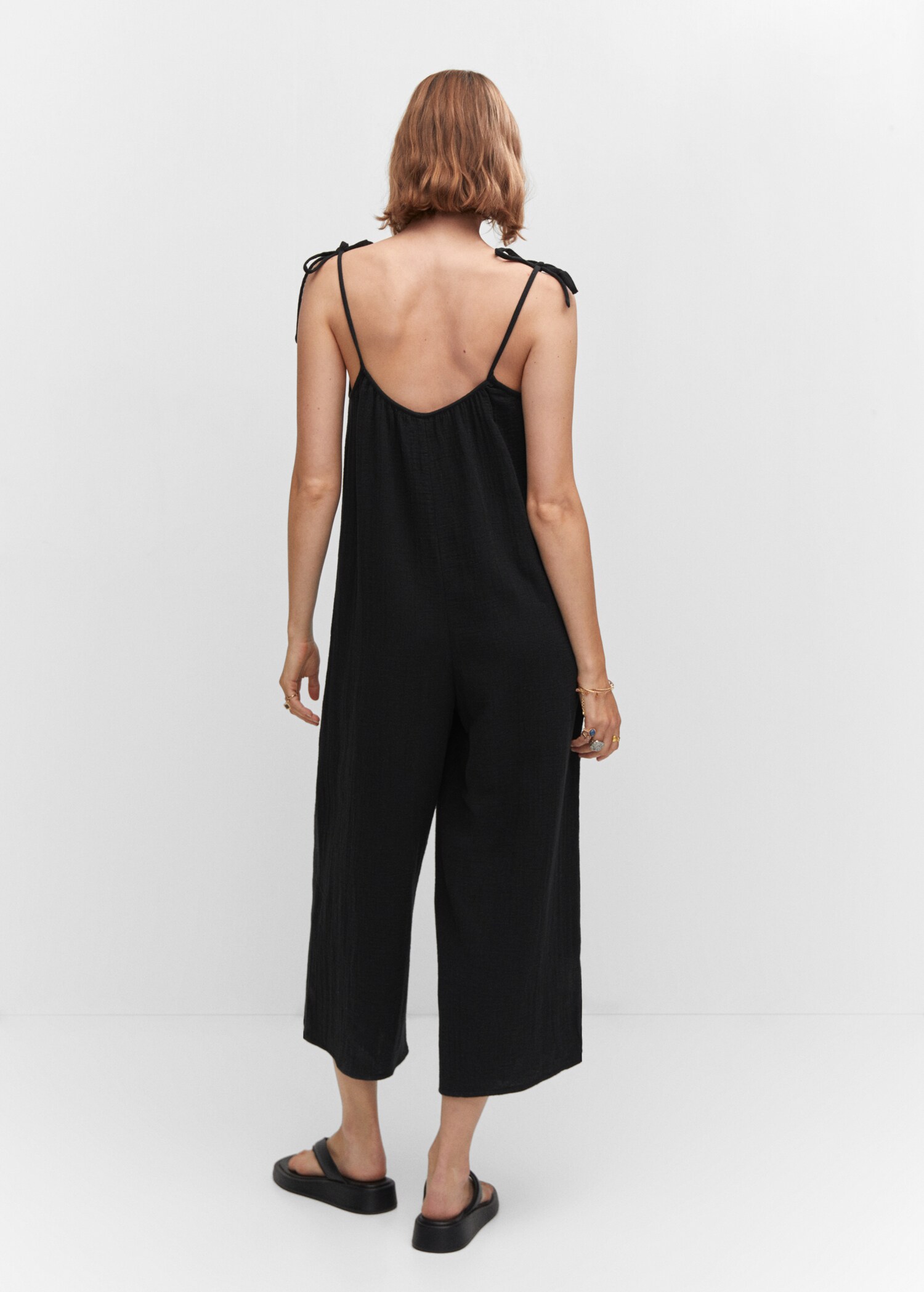 Textured jumpsuit with bows - Reverse of the article