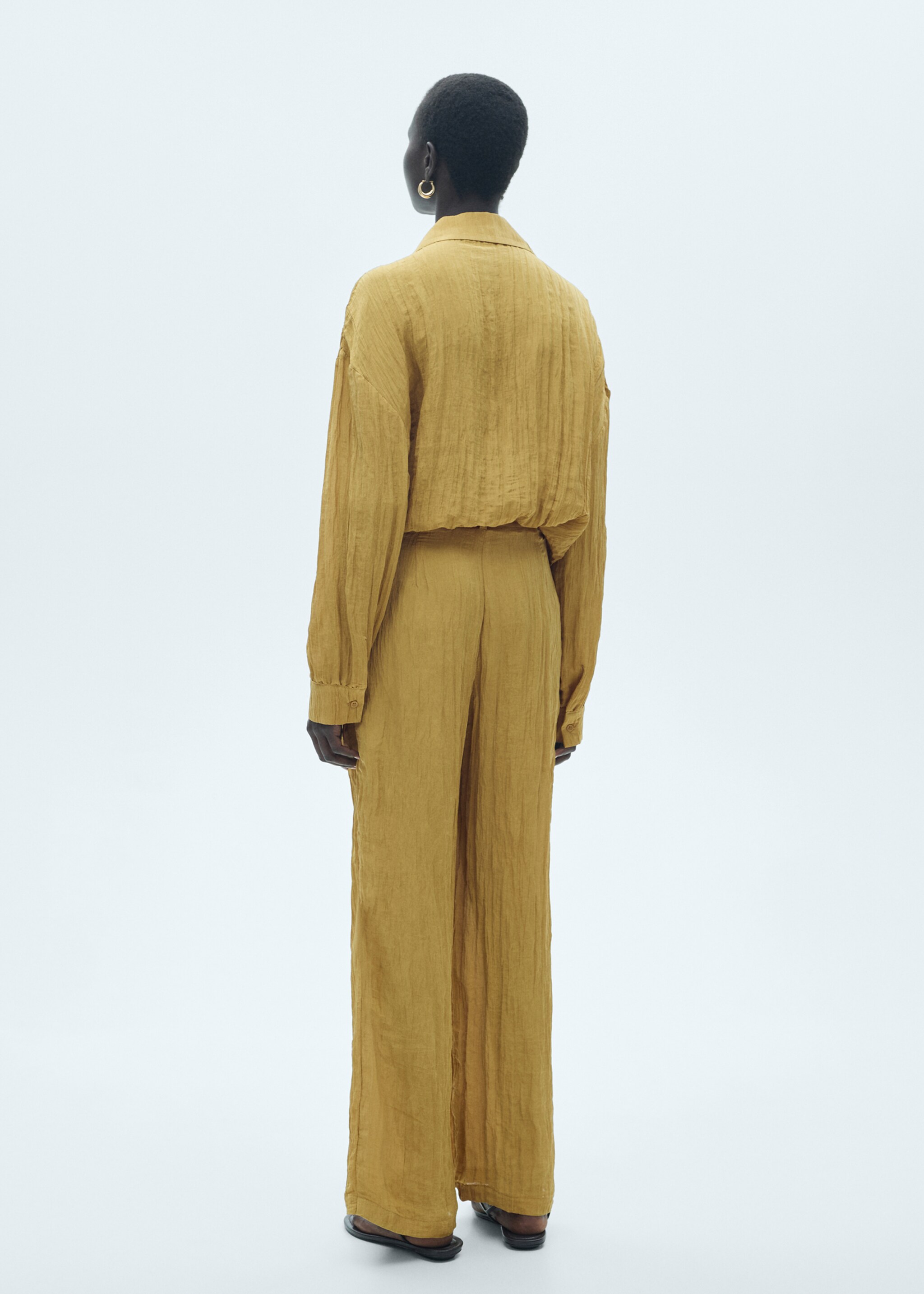 Textured trousers with belt - Reverse of the article