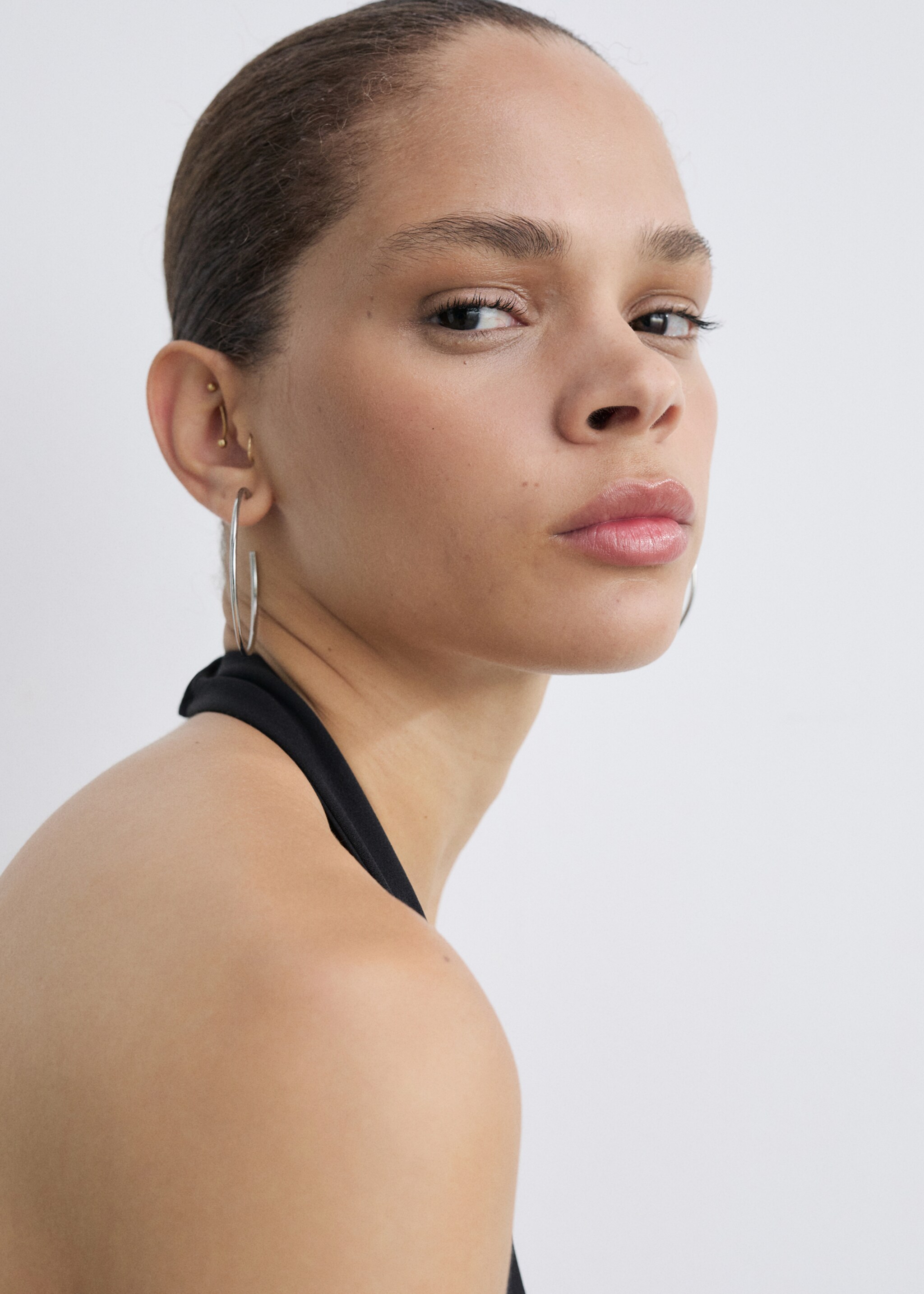 Halter-neck jumpsuit with belt - Details of the article 1, Black. Ref: 77074455-00.