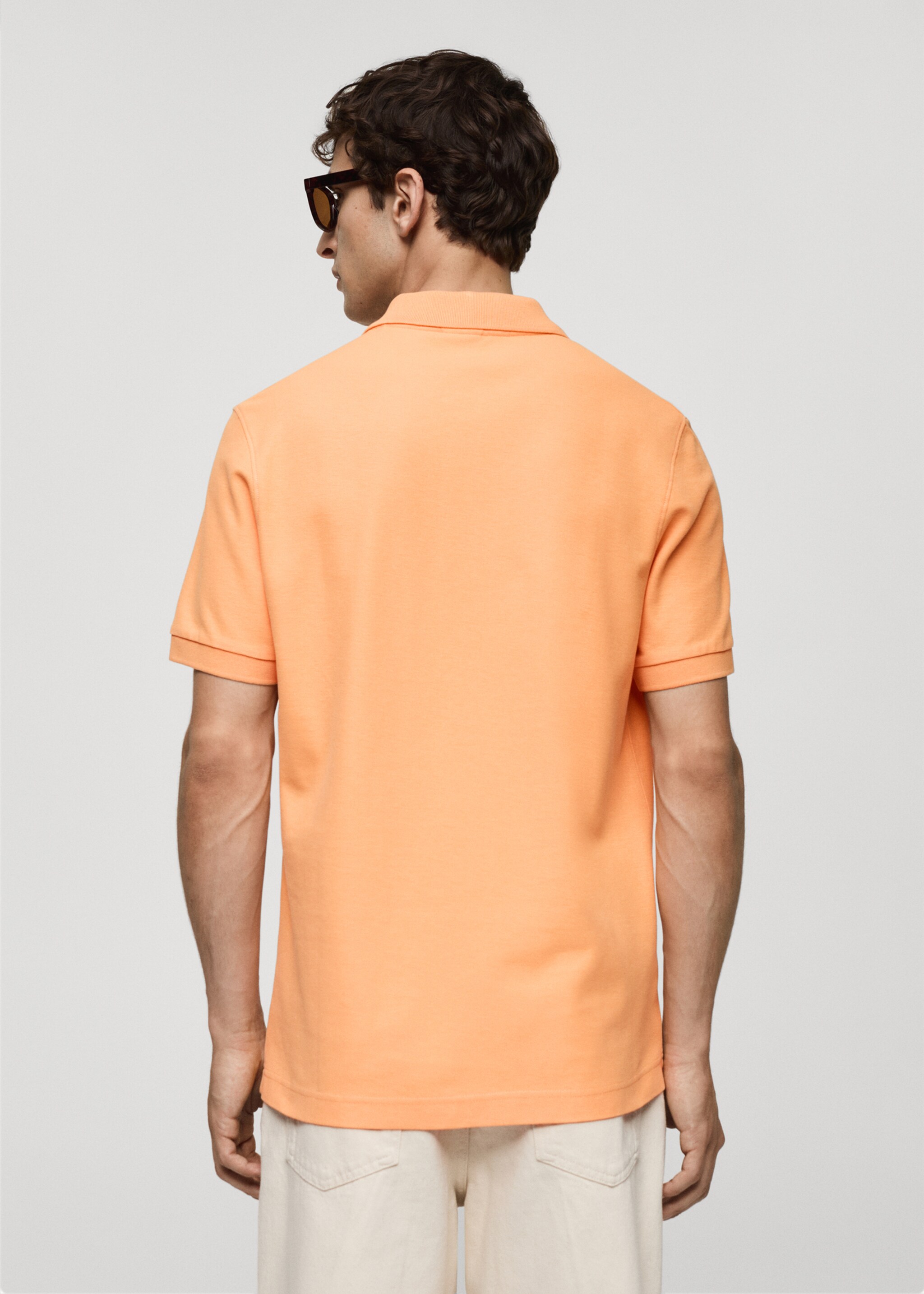 Polo 100 % piqué de coton - Verso de l’article, Orange pastel. Ref: 77090584-00.