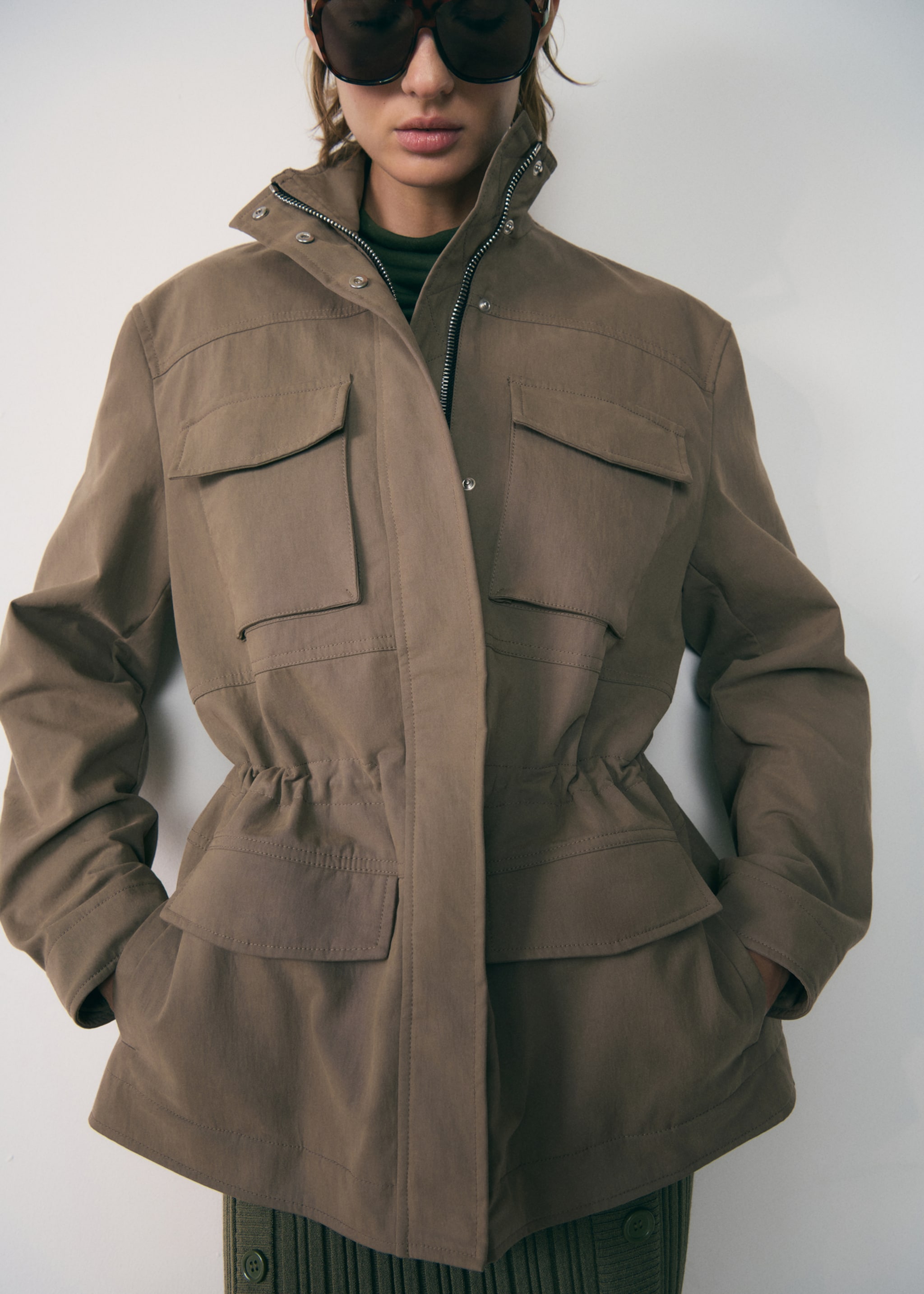 Turtleneck parka with pockets - Details of the article 1, Medium Brown. Ref: 77947938-00.